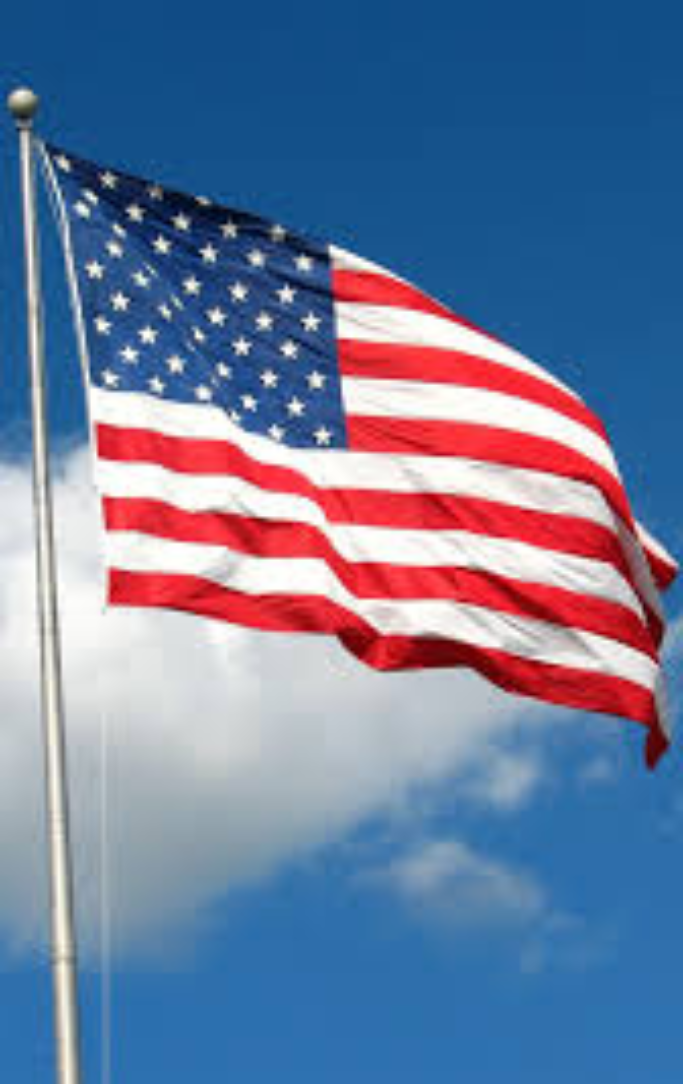Blue sky and cloud with American flag on flag pole.